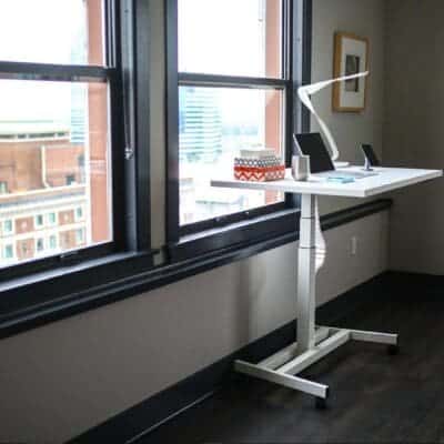The Andern Pneumatic Standing Desk in front of window.