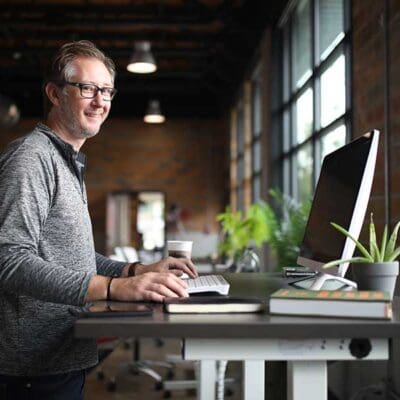 Jake at Kloud Standing Desk in Office