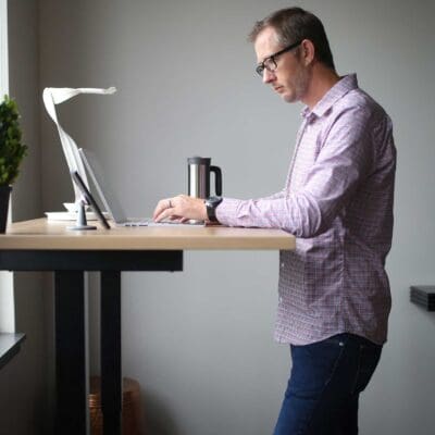 Jake working on laptop at standing desk